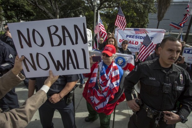 LOS ANGELES, CA - FEBRUARY 18: A small group of Trump supporters confronts marchers during the Immigrants Make America Great March to protest actions being taken by the Trump administration on February 18, 2017 in Los Angeles, California. Protesters are calling for an end to stepped up ICE raids and deportations, and that health care be provided for documented and undocumented people.   David McNew/Getty Images/AFP