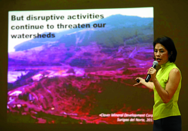  DENR Sec. Gina Lopez with a copy of the DENR Mine Audit Report during a press briefing on Mineral Production Sharing Agreement and an overview on mining sites located in different watersheds in the Philippines. Image in the background is site of Claver Mineral Development Corp. operations in Surigao del Norte taken this year. INQUIRER PHOTO/LYN RILLON
