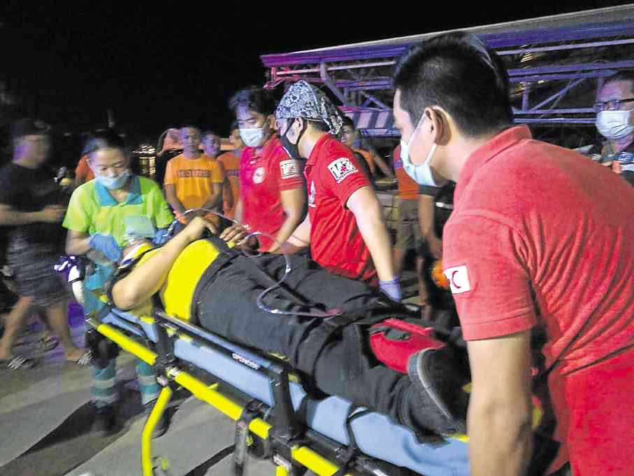 First aid responders carry a passenger of MV St. Braquiel on a stretcher after the vessel collided with a barge carrying empty cases and bottles of beer on Mactan Channel. —CHRISTIAN MANINGO/CEBU DAILY NEWS