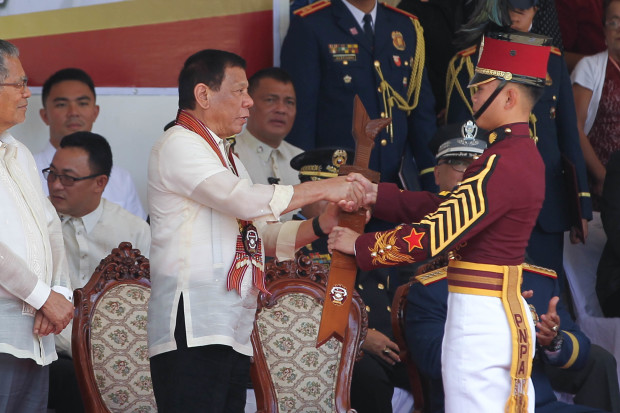 President Rodrigo Roa Duterte presents the Presidential Kampilan Award to class valedictorian P/Cdt. Macdum Enca during the 38th Philippine National Police Academy (PNPA) Commencement Exercises for 'Masidlak' Class of 2017 at Camp General Mariano N. Castañeda in Silang, Cavite on March 24, 2017. ROBINSON NIÑAL JR./Presidential Photo