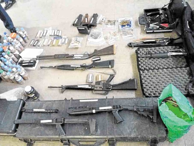 The guns and ammo allegedly kept by the occupants of No. 36 Tandang Sora Avenue—PHOTO COURTESY OF THE QCPD 