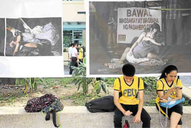 A “Pieta-like” photo by Inquirer lensman Raffy Lerma (right) finds a prominent spot on the FEU campus. 