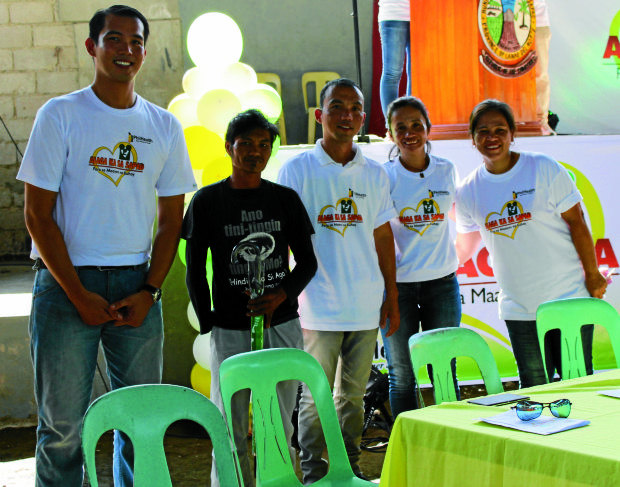 ON HIGH GROUND Dreyfuss Perlas (left, with staff from PhilHealth) actively worked on projects that advanced the health system in the countryside. —Photo courtesy of PhilHealth Iligan