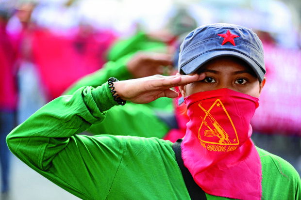 RED SALUTE  A woman member of the communist underground movement joins the rally in Cubao, Quezon City, to celebrate in advance the founding anniversary of the New People’s Army, which was established on March 29, 1969. —NIÑO JESUS ORBETA