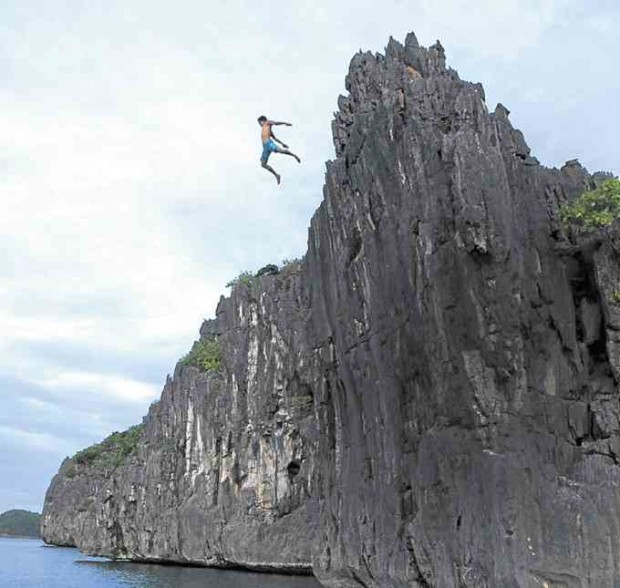 ADVENTURE FIXThrill-seekers brave the rock formations of Caramoan Peninsula in Camarines Sur province to try cliff diving.  —CONTRIBUTED PHOTO BY THE PROVINCIAL GOVERNMENT OF CAMARINES SUR