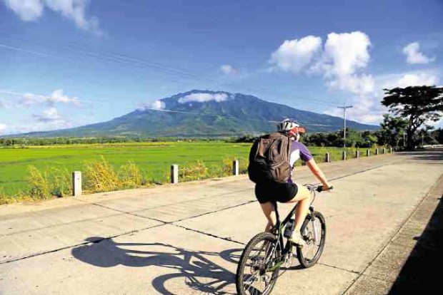 A biker gets a clear view of Mt. Isarog as he explores Camarines Sur. —MARK ALVIC ESPLANA 
