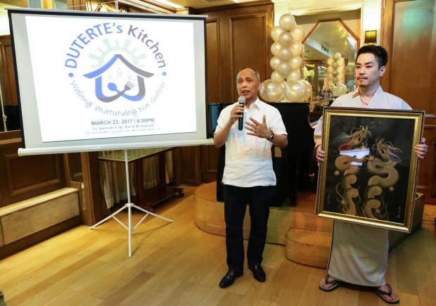 Energy Secretary Alfonso Cusi politely declines a gift from Japanese artist Keisuke Teshima and suggests instead that it be auctioned for calderos of lugaw for Duterte's Kitchen. CONTRIBUTED PHOTO
