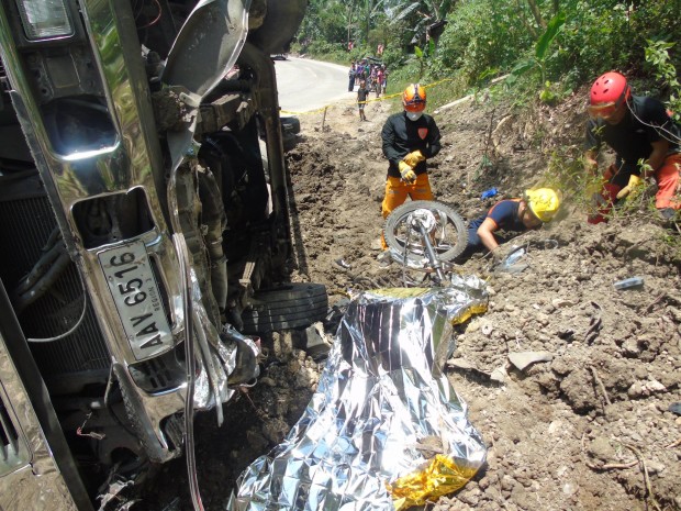 Rescuers dig for the bodies of three victims crushed to death by a ten-wheeler truck in an accident in Atimonan, Quezon, on Saturday, March 11, 2017. CONTRIBUTED PHOTO 