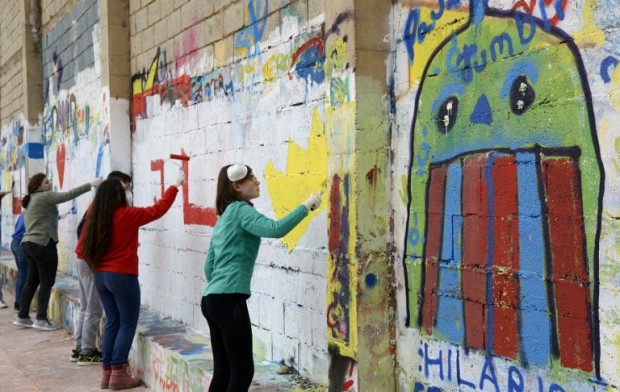 Youths paint a wall in the local sports centre during a visit to Fanzara near Castellon de la Plana, on December 15, 2016. Fanzara, a Spanish hamlet in the mountainside, nestled in the hinterland of Valencia has for years sufferred from local political quarrels. Recently a new breath of life has washed over the town thanks to urban artists from all over the world who have helped to heal its wounds. Photo from AFP.