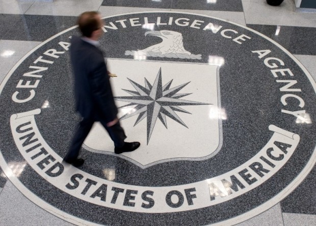 (FILES) This file photo taken on August 13, 2008 shows a man walking over the seal of the Central Intelligence Agency (CIA) in the lobby of CIA Headquarters in Langley, Virginia. The CIA can turn your TV into a listening device, bypass popular encryption apps, and possibly control your car, according to a trove of alleged documents from the US spy agency released on March 7, 2017 by WikiLeaks. The group posted nearly 9,000 documents it said were leaked from the Central Intelligence Agency, in what it described as the largest-ever publication of secret intelligence materials.  / AFP PHOTO / AFP FILES / SAUL LOEB
