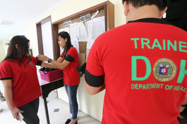 Department of Health workers in Central Visayas wear black armbands to work, on March 6, 2017, to highlight their call for justice for Dr. Dreyfuss Perlas who was shot dead in Sapad, Lanao del Norte. on March 1, 2017. (PHOTO BY JUNJIE MENDOZA / CDN)