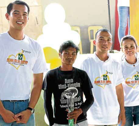 Dr. Dreyfuss Perlas (left) joins an activity of the Philippine Health Insurance Corp. in this photo furnished by the agency’s Iligan City office.