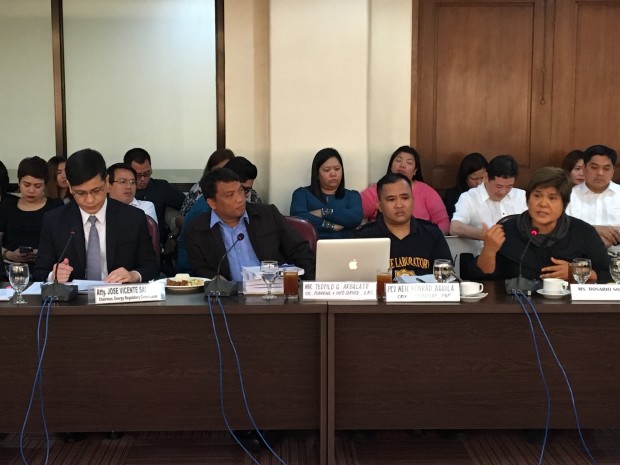 ERC Chairman and Chief Executive Officer Jose Vicente Salazar and journalist Charie Villa, the sister of late ERC Director Francisco Villa Jr., are seated only a couple of chairs apart as she pinned him down for the executive's suicide. VINCE F. NONATO/INQUIRER