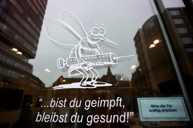 A text reads "you're vaccinated, you stay healthy" on the door of a doctor office in Hamburg, northern Germany, during Germany's worst outbreak in years of measles. A toddler has died of measles on February 18 in Berlin, health authorities said on February 23, announcing the first known fatality among more than 500 measles cases since October in the German capital.  AFP PHOTO / DPA / CHRISTIAN CHARISIUS +++ GERMANY OUT / AFP PHOTO / DPA / CHRISTIAN CHARISIUS