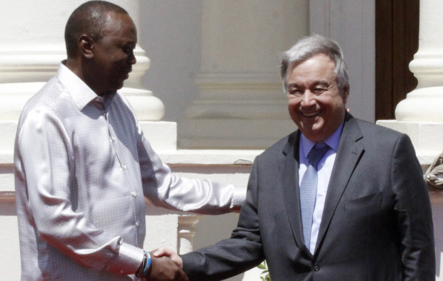 UN secretary general Antonio Guterres, right, shakes hands with Kenyan President Uhuru Kenyatta  (AP Photo/Khalil Senosi)