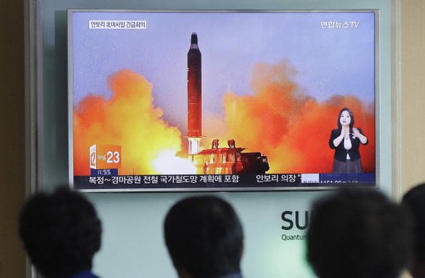 FILE - In this June 23, 2016, file photo, people watch a TV news channel airing an image of North Korea's ballistic missile launch published in North Korea's Rodong Sinmun newspaper at the Seoul Railway Station in Seoul, South Korea.  North Korea on Monday, March 6, 2017, fired "several" banned ballistic missiles that flew about 1,000 kilometers (620 miles) into waters off its east coast, South Korea's military said, an apparent reaction to huge military drills by Washington and Seoul that Pyongyang insists are an invasion rehearsal.(AP Photo/Ahn Young-joon, File)