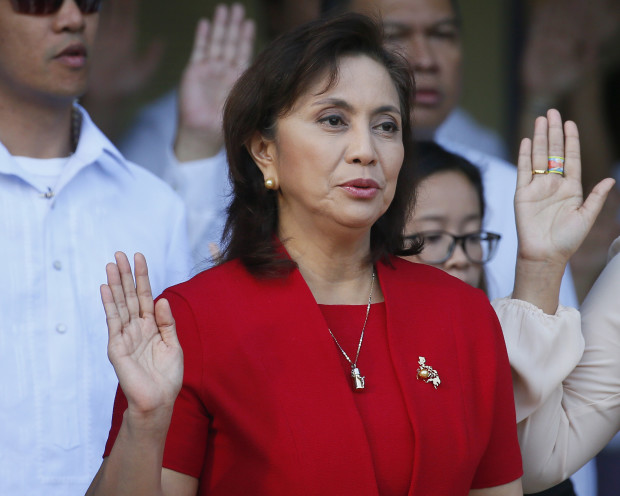 Philippine Vice-president Maria Leonor "Leni" Robredo takes an oath to the nation during flag-raising rites at the Quezon City hall Monday, March 20, 2017 in suburban Quezon city northeast of Manila, Philippines. House Speaker Pantaleon Alvarez said last week, he is mulling to file impeachment complaint against Robredo for sending a video message to the United Nations Side Session at the Comission on Narcotic Drugs Annual Meeting allegedly criticizing extra-judicial killings in the so-called war on drugs by President Rodrigo Duterte. Duterte himself is the object of an impeachment complaint filed by another congressman for the thousands of killings in the country.(AP Photo/Bullit Marquez)