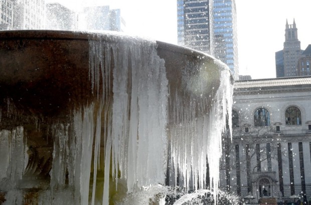 The  Josephine Shaw Lowell Memorial Fountain in Bryant Park is covered in ice on March 13, 2017 as the weather continues to be below freezing.  The northeastern United States braced Monday for what meteorologists predict could be the worst winter storm of the season, with blizzards feared to dump knee-high snow on New York. / AFP PHOTO / TIMOTHY A. CLARY