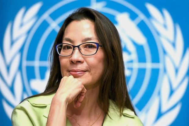 Chinese Malaysian actress Michelle Yeoh smiles during a press conference presenting the winners of the Global Road Safety Film Festival 2017, on February 21, 2017 at the UN offices in Geneva. / AFP PHOTO / FABRICE COFFRINI