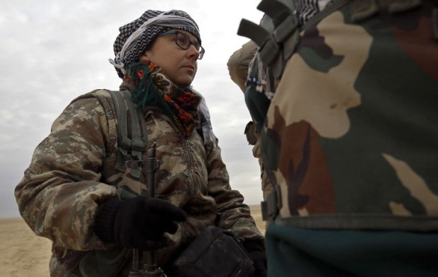 Kimmy Taylor, a 27-year-old British citizen who joined the Kurdish People's Protection Units (YPG), talks with her comrades near Khunayz on the northern outskirts of Raqa on March 5, 2017. Captivated by the idea of fighting jihadists, or dedicated to starting a "revolution," foreigners have diverse reasons for joining the YPG in northern Syria. The group is the key component of the US-backed Syrian Democratic Forces alliance, now advancing on the Islamic State group's stronghold of Raqa. Photo by AFP.