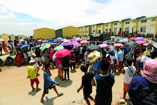 Settlers gather at the Atlantica housing project in Pandi town, Bulacan province, to get updates from their leaders on the status of their stay in the government-owned site.  —JOAN BONDOC