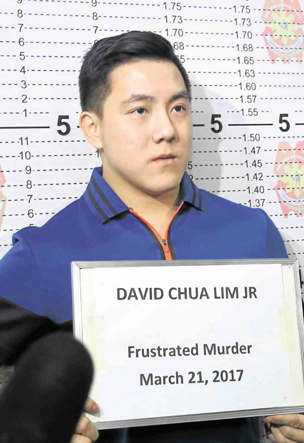 Wealthy scion David Lim Jr. had his mug shot taken at the regional police office following his surrender to face a road rage shooting case. —JUNJIE MENDOZA/CEBU DAILY NEWS