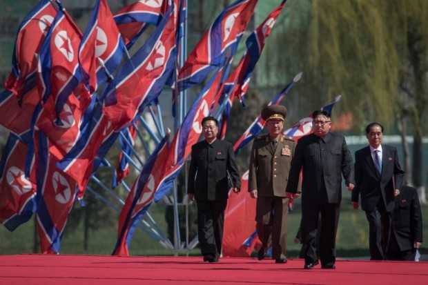 North Korean leader Kim Jong-Un (2nd R) arrives flanked by vice-chairman of the State Affairs Commission Choe Yong-Hae (L) and prime minister Pak Pong-Ju (R) at an opening ceremony for 'Rymoyong street', a new housing development in Pyongyang, on April 13, 2017. With thousands of adoring North Koreans looking on -- along with invited international media -- Kim Jong-Un opened a prestige housing project as he seeks to burnish his nation's image even as concerns over its nuclear capabilities soar. / AFP PHOTO / ED JONES