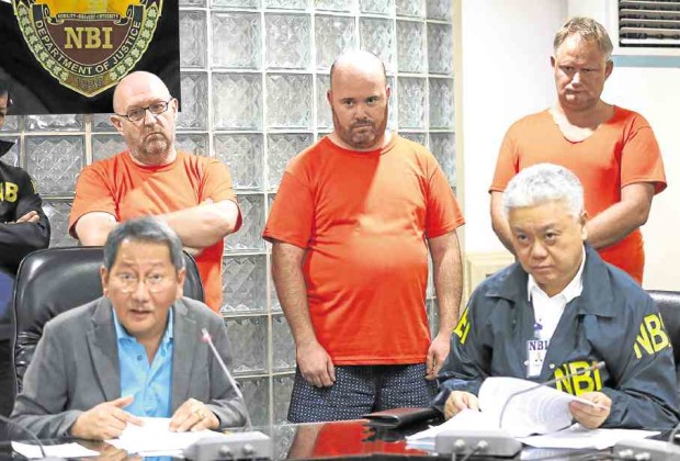 British nationals Graham Allan Bennet, Andrew Robson and Dominic Whellams are presented at the NBI following their arrest in Carmona, Cavite, on Wednesday. Thirty-five of their Filipino personnel were also rounded up for alleged sale of nonexistent bonds and securities to investors outside the country.—LYN RILLON