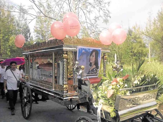 FAREWELL Balloons adorn the carriage bearing the casket of Mary Christine Balagtas on Palm Sunday. CARMELA REYES-ESTROPE