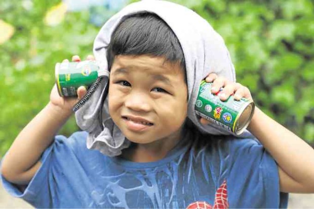 NEXT MEALA boy brings home two cans of sardines in exchange for trash collected in their neighborhood in Cebu City. —TONEE DESPOJO / CEBU DAILY NEWS
