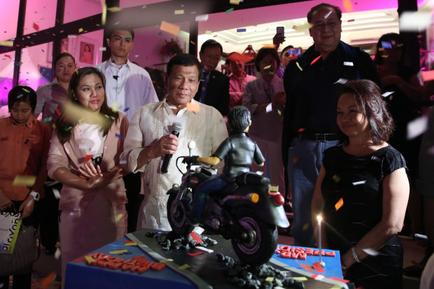 President Rodrigo Roa Duterte blows the candle of the birthday cake given by Former President and Incumbent Pampanga Second District Representative Gloria Arroyo  during the former President's 70th birthday celebration at La Vista Subdivision in Quezon City on April 5, 2017. The President celebrated his 72nd birthday on March 28, 2017. Also in the photo are the President's partner Honeylet Avanceña and the former President's husband Jose Miguel Arroyo. ALFRED FRIAS/Presidential Photo