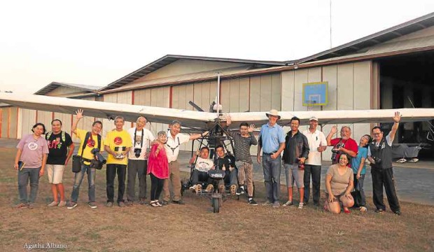 Proud mothers and mentors led by John Chua pose by the ultralight plane used by ASD youth. —AGATHA ALBANO