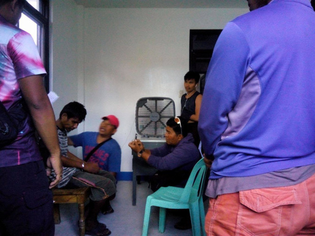 Albert Laguna is seen being interrogated by the police in Clarin town, Bohol, on Apr. 25, 2017, after he was found wandering in Barangay Bacani,  the site of the recent clash between Abu Sayyaf members and government troops in Clarin. The identity of Laguna, a civilian suffering from mental illness, was later confirmed by officials of Catigbian in Bohol, where he resides. Laguna has been freed and cleared of ties to Abu Sayyaf. (PHOTO BY LEO UDTOHAN / INQUIRER VISAYAS) 