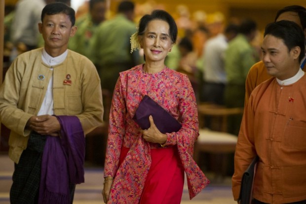 (FILES) This file photo taken on February 1, 2016 shows Myanmar's National League for Democracy (NLD) chairperson Aung San Suu Kyi (C) leaving after the new lower house parliamentary session in Naypyidaw. For decades Myanmar's people dreamed of democracy, but a year into office Aung San Suu Kyi's elected government is struggling to revive the sluggish economy and shake off the vestiges of the still powerful military. / AFP PHOTO / Ye Aung Thu