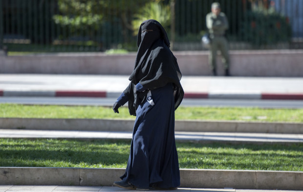 A woman wearing a niqab walks along a street in Rabat on January 15, 2017. Morocco's ban on the sale and production of burqa full-face Muslim veils beloved of Salafists has sharply divided opinions in the North African country. AFP 