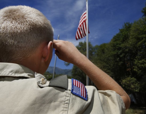 PAYSON, UT - JULY 31: A Boy Scout salutes the American flag at camp Maple Dell on July 31, 2015 outside Payson, Utah. The Mormon Church is considering pulling out of its 102 year old relationship with the Boy Scouts after the Boy Scouts changed it's policy on allowing gay leaders in the organization. Over 99% of the Boy Scout troops in Utah are sponsored by the Mormon Church.   George Frey/Getty Images/AFP