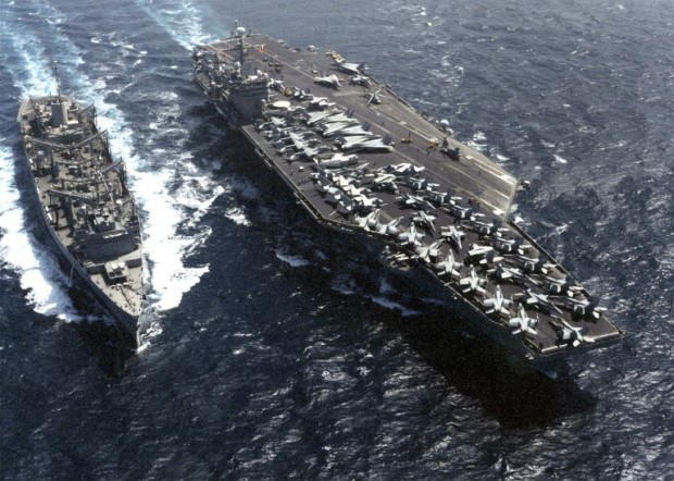 In this photo released 13 October 2001 by the US Navy, the aircraft carrier USS Carl Vinson (R) and the fast combat support ship USS Sacramento (L) steam side-by-side during a routine replenishment at sea (RAS).  The Vinson is conducting flight operations against terrorist training camps and Taliban military installations in Afghanistan. The actions are designed to disrupt the use of Afghanistan as a base for terrorist operations and to attack the military capability of the Taliban regime in support of Operation "Enduring Freedom."  AFP PHOTO /US/NAVY/Carol WARDEN  / AFP PHOTO / US NAVY / CAROL WARDEN