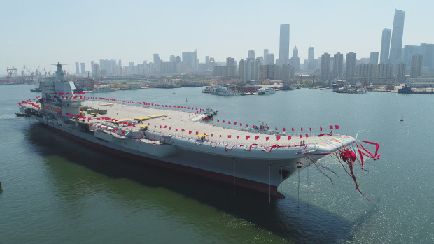 In this photo released by China's Xinhua News Agency, a newly-built aircraft carrier is transferred from dry dock into the water at a launch ceremony at a shipyard in Dalian in northeastern China's Liaoning Province, Wednesday, April 26, 2017. China launched its first aircraft carrier built entirely on its own on Wednesday, in a demonstration of the growing technical sophistication of its defense industries and determination to safeguard its maritime territorial claims and crucial trade routes. (Li Gang/Xinhua via AP)