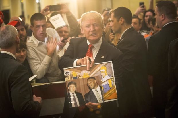 Donald Trump showing photo depicting him in The Simpsons - 29 Jan 2016