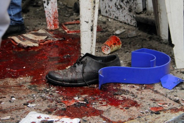 EDITORS NOTE: Graphic content / Blood and debris are seen on a street near a church in Alexandria after a bomb blast struck worshippers gathering to celebrate Palm Sunday on April 9, 2017. The Interior ministry said Coptic Pope Tawadros II was inside the church leading a Palm Sunday service when the suicide bomber was stopped by police outside and blew himself up. A church official said Tawadros had already left the church when the bombing took place. / AFP PHOTO / STRINGER