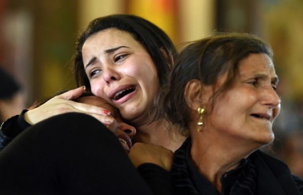 Women mourn for the victims of the blast at the Coptic Christian Saint Mark's church in Alexandria the previous day during a funeral procession at the Monastery of Marmina in the city of Borg El-Arab, east of Alexandria, on April 10, 2017. Egypt prepared to impose a state of emergency after jihadist bombings killed dozens at two churches in the deadliest attacks in recent memory on the country's Coptic Christian minority. / AFP PHOTO / MOHAMED EL-SHAHED