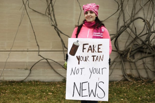 (FILES) This file photo taken on January 21, 2017 shows protesters displaying a sign referring to "Fake News" in Washington, DC, during the Women’s March on January 21, 2017.  The rise of fake news has been a hot topic in Britain this year, with the lawmaker leading a probe into the phenomenon warning it was "a threat to democracy".  / AFP PHOTO / Joshua LOTT