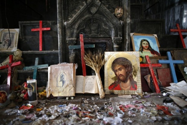Crucifixes and icons are seen at the heavily damaged Church of the Immaculate Conception in Qaraqosh (also known as Hamdaniya), some 30 kilometres east of Mosul, on April 9, 2017, as Christians mark the first Palm Sunday event in the town since Iraqi forces recaptured it from Islamic State (IS) group jihadists. Qaraqosh, with an overwhelmingly Christian population of around 50,000 before the jihadists took over the area in August 2014, was the largest Christian town in Iraq. / AFP PHOTO / AHMAD GHARABLI