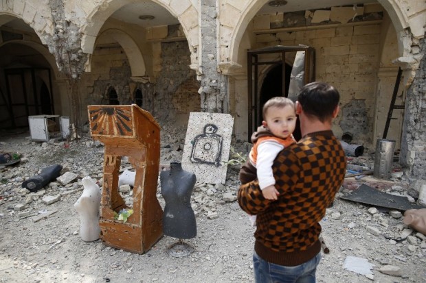 Iraqi Christian residents of Qaraqosh (also known as Hamdaniya), some 30 kilometres east of Mosul, visit the heavily damaged Church of the Immaculate Conception on April 9, 2017, as Christians celebrate the first Palm Sunday event in the town since Iraqi forces recaptured it from Islamic State (IS) group jihadists. Qaraqosh, with an overwhelmingly Christian population of around 50,000 before the jihadists took over the area in August 2014, was the largest Christian town in Iraq. / AFP PHOTO / AHMAD GHARABLI
