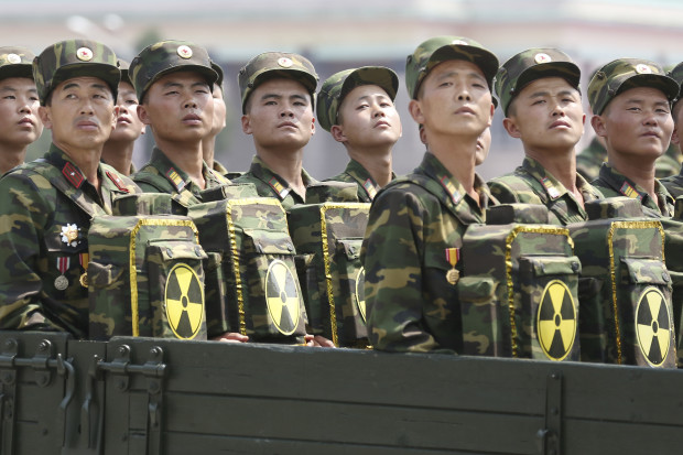 In this July 27, 2013, file photo, North Korean soldiers turn and look towards leader Kim Jong Un as they carry packs marked with the nuclear symbol at a parade in Pyongyang, North Korea. North Korea's vice foreign minister Han Song Ryol said in an interview with the Associated Press on Friday, April 14, 2017: "We've got a powerful nuclear deterrent already in our hands, and we certainly will not keep our arms crossed in the face of a U.S. pre-emptive strike." (AP Photo/Wong Maye-E, File)
