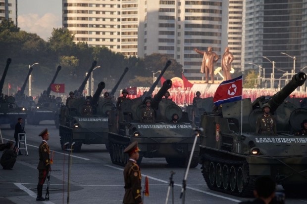North Korean soldiers ride atop tanks during a mass military parade at Kim Il-Sung square in Pyongyang on October 10, 2015. North Korea was marking the 70th anniversary of its ruling Workers' Party. AFP PHOTO / Ed Jones / AFP PHOTO / ED JONES
