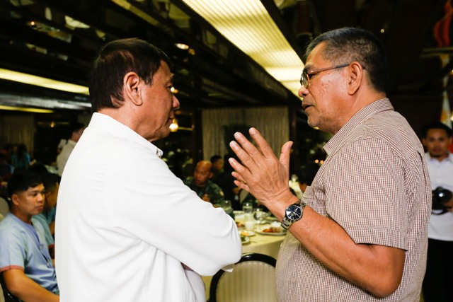 In this Aug. 30, 2016 file photo, President Rodrigo Duterte talks with Interior Secretary Ismael Sueno. (Photo from the Presidential Communications Operations Office at www.pcoo.gov.ph )