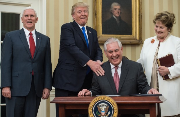 US President Donald Trump (2L) congratulates Rex Tillerson (seated) after he was sworn in as Secretary of State as his wife Renda St. Clair (R), and Vice President Mike Pence (L) look on in the Oval Office at the White House in Washington, DC, on February 1, 2017. AFP FILE PHOTO