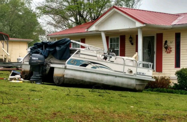 A pontoon boat sits in the front yard of a home in the Screamer community of Henry County, Ala., after a suspected tornado touched down in the county Wednesday, April 5, 2017. National Weather Service meteorologist Mark Wool said a suspected tornado touched down Wednesday in Henry County, Alabama, before crossing into Georgia. (Michele W. Forehand/Dothan Eagle via AP)