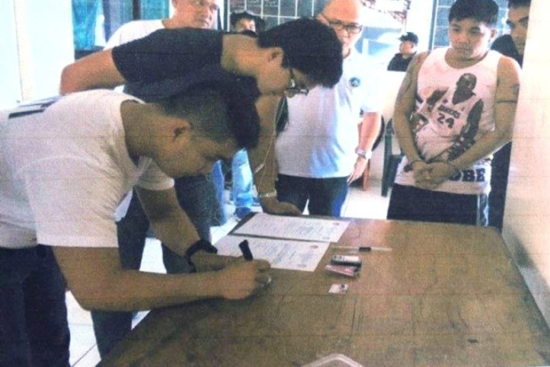 A drug suspect undergoes a booking proceeding in Leyte. ROBERT DEJON/INQUIRER VISAYAS